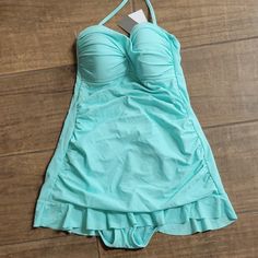 Kenneth Cole Reaction Mint Green One Piece Swimsuit With Ruffled Skirt. Ruched Sides. Built In Padded Bra. One Strap That Goes Around Neck. Lined. 82% Nylon 18% Elastane. Lining 100% Polyester. Size 4. New With Tags Stretch Swim Dress With Ruffles For Pool, Fitted Ruffle Swim Dress For Beach Season, Stretch Swim Dress With Ruffles For Spring, Fitted Ruffle Swim Dress For Pool, Summer Fitted Swim Dress With Ruffles, Fitted Summer Swim Skirt With Ruffles, Fitted Ruffle Swim Skirt For Summer, Stretch Ruffled Swim Dress For Spring, Fitted Summer Swim Dress With Ruffles