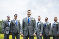 a group of men in suits standing next to each other