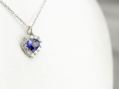 We've set this classic pendant with a deep blue sapphire of excellent quality. The setting is filled with bright white diamonds, reflecting brilliance and life into this gorgeous gemstone. This pendant does not come with the chain shown. Please feel free to contact us, we will help you find the perfect chain for your style and budget! Metal: 18K White Gold Gem: Sapphire 1.03 Carats Gem Measurements: 5.7 x 7.1 mm, Pear Cut Accents: 12 Diamonds totaling .36 Carats, G in Color, VS in Clarity Measurements: 11 x 16 mm, with bail Marks: "18K" Stamped on the reverse Sapphire Gemstone Diamond Pendant Necklace, Sapphire Diamond Cut Necklace, Sapphire Gemstone Pendant Diamond Necklace, Sapphire Pendant Diamond Necklace In White Gold, Diamond White Sapphire Pendant Necklace, Sapphire Pendant Diamond Necklace, Silver Sapphire Necklace With Heart Cut, Sapphire Diamond Cut Pendant Necklace, Sapphire Diamond Pendant Necklace