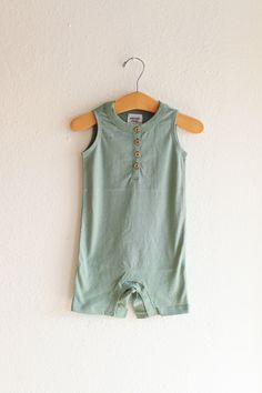 A fresh take on the ultimate summer one piece - the Henley Romper for babies. This lightweight, adorable outfit is as cute as it is functional. Here are the deets:- Super Soft 100% Organic Cotton- Runs true to size.- Pre-Shrunk- Ethically sourced and sustainably produced from a GOTS Certified Organic factory .- Printed using eco-friendly water-based inks.- Super soft, flexible lightweight material.- Metal five snap closure for easy diaper changes- Sewn in label in neckline, hangtag attached Gender Neutral Outfit, Summer One Piece, Organic Cotton Baby, Neutral Outfit, Baby One Piece, Cotton Baby, Guinea Bissau, Mozambique, Green Bay