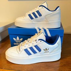 Classic Adidas 3-Stripes Style In A Trendy Platform Sneaker! The Forum Bonega Has A Premium Leather Upper, Memory Foam Sockliner (Comfy), And Rubber Platform Outsole. All White With Blue 3-Stripes And A Gold Adidas Trefoil Logo On Side. Regular Fit. Nwt Comes In Original Adidas Box. Ol5ss5x1a7 Forum Bonega Shoes, Bonega Shoes, Best Work Shoes, Shoe Storage Ideas, Gold Adidas, Classic Adidas, Pretty Shoes Sneakers, Adidas Classic, Shoes Too Big