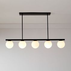 three lights hanging from the ceiling in a room