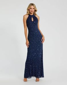 a woman in a long blue dress with sequins on the neck and back