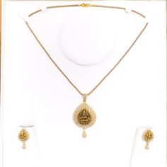 Embrace luxury with our Impressive Lakshmi 22k Gold CZ Pendant Set. Crafted from 14.5g of pure 22k gold, adorned with dazzling Cubic Zirconia. The pendant boasts a 2.2" length, complemented by matching 1" earrings with secure screw backs. Elevate your style with this exquisite 3-piece set. PRODUCT DETAILS Gold Purity(karat): 22k Item Weight(grams): 14.5 Item Finish: Yellow Gold Stone: Cubic Zirconia Pendant Length: 2.2" Matching Earrings: Included Earring Length: 1" Earring Post: Screw Back Numb 22k Yellow Gold Jewelry Sets For Puja, Elegant 22k Gold Jewelry Sets For Puja, Festive Gold Diamond Temple Necklace, Traditional Jewelry Sets With Diamond Accents, Festive Gold Temple Necklace With Diamonds, Festive Gold Diamond Necklace Hand Set, Festive Gold Diamond Necklace With Hand-set Details, 22k Gold Jewelry With Single Cut Diamonds, Gold Diamond Necklace Hand Set For Festive Occasion