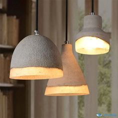 two cement lamps hanging from a ceiling