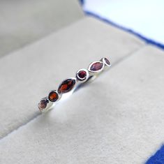 Tiny delicate vintage art deco garnet wedding ring, Small & dainty sterling silver marquise cut garnet womens wedding band, Garnet jewelry ------------------------------------------------------------------------------------------------------------------------------------------------------------------------------------------------------------- Garnet Wedding Ring ◈ Item Details ◈ Metal : Sterling Silver Metal Purity: 925 Parts Per 1000 Style : Vintage Ring Main Stone : Natural Garnet  Stone Size : 2x4 mm Stone Shape : Marquise  Other Stone : Garnet  Occasion : Party , Anniversary , Wedding Personalization : Possible 925 sterling silver with silver/white/yellow/rose gold plated. Sent in a very elegant wedding ring box, ready for one special lady. Customization is always welcome and please fe Elegant Marquise Sterling Silver Ring, Heirloom Sterling Silver Stackable Jewelry, Elegant Sterling Silver Stackable Rings With Gemstone, Formal Stackable Cubic Zirconia Jewelry, Heirloom Stackable Jewelry With Cubic Zirconia, Heirloom Stackable Cubic Zirconia Jewelry, Dainty Round Amber Jewelry, Elegant Round Cut Garnet Jewelry, Dainty Amber Round Jewelry