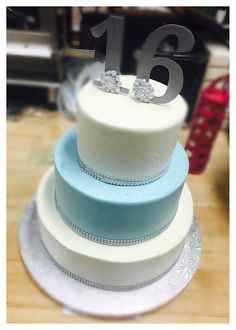 a white and blue cake sitting on top of a table