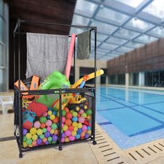 a swimming pool filled with toys next to a towel rack and umbrellas on top of it