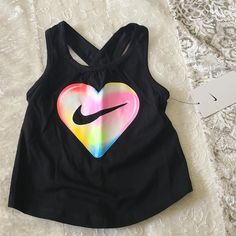 New The Nike Tank Is Sure To Be A Flowy Favorite. Featuring A Bright Graphic Print On Front And A Keyhole Detail On Back, This Tank Will Help Keep Kiddos Comfy At Play. Soft Cotton Fabric Feels Comfortable And Lightweight. Standard Fit For A Relaxed, Easy Feel. 100% Cotton Black Summer Playwear Tops, Multicolor Graphic Print Tops For Playwear, Sporty Tops For Summer Playtime, Black Cotton Tops For Playwear, Nike Sporty Tops For Playwear, Sporty Nike Top For Playwear, Trendy Letter Print Tops For Playtime, Casual Multicolor Tops For Play, Playful Multicolor Tops For Play