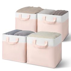 three pink storage bins with white handles and two grey ones, one light pink