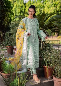 Mint Green Pakistani Dress in Salwar Kameez Style is an elegant masterpiece that gives you your desired dreamy appearance on a festive occasion. Embroidery work and lavish designs on this beautiful Salwar Kameez make it an exquisite choice for the big day. Kameez: The mint-colored kameez comes in textured organza fabric. Beautiful embroidery work and floral designs give a mesmerizing look to the kameez. The kameez is paired with a cotton silk slip. Intricate designs and fine details make this ka Designer Pista Green Dress With Intricate Embroidery, Pista Green Dupatta With Intricate Embroidery For Eid, Pista Green Dress With Intricate Embroidery For Diwali, Pista Green Dress With Intricate Embroidery For Festive Occasions, Eid Pista Green Dupatta With Intricate Embroidery, Eid Pista Green Embroidered Dupatta, Festive Pista Green Dress With Intricate Embroidery, Anarkali Lawn Suit With Intricate Embroidery For Eid, Designer Lawn Suit With Intricate Embroidery For Eid