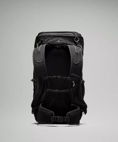 the back view of a black backpack on a gray background