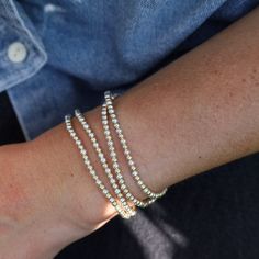 Whether worn alone for a touch of understated luxury or stacked with other bracelets for a bold statement, these Ball Bead Bracelets add a touch of glamour to any outfit, for any occasion. Made to be worn in the pool, shower, ocean, or wherever your bohemian adventures take you. Waterproof | Tarnish Free | Hypoallergenic Classic 3mm beads Options: 14K gold filled, Sterling Silver, or Two Tone High Performance Elastic Made in Miami Dainty Beaded Bracelets For Party, Dainty Stackable Bracelets For Party, Elegant Gold Stackable Wrap Bracelet, Trendy Stackable Beaded Bracelets For Party, Silver Wrap Bracelet With Faceted Beads, Silver Flexible Bracelet For Everyday Wear, Flexible Silver Bracelets For Party, Elegant Silver Wrap Bracelet With Faceted Beads, Silver Flexible Bracelets For Everyday Wear