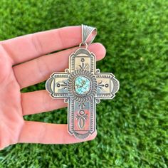 This gorgeous and rare cross pendant was created by Navajo artisan Albert Jake. Handmade from sterling silver, this pendant accents intricate deep stampwork detailed with symmetrical perfection, twist wire, and a natural, gem grade Number 8 turquoise stone. A unique, stand-out addition to any collection. Bale fits up to 10 millimeter Navajo Pearls (NOT included) Measures 2 5/8" long not including bale (3 3/8" long including bale) x 2 1/8" wide at the largest points Weighs 20.5 grams Model is wea Handmade Southwestern Cross Necklace, Southwestern Handmade Cross Necklace, Bohemian Turquoise Cross Jewelry, Bohemian Turquoise Cross Pendant Jewelry, Bohemian Cross Pendant Jewelry, Handmade Turquoise Cross Necklace Spiritual, Handmade Southwestern Cross Pendant Jewelry, Handmade Southwestern Style Cross Pendant Jewelry, Handmade Spiritual Turquoise Cross Necklace