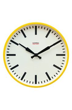 a white and yellow clock with black hands