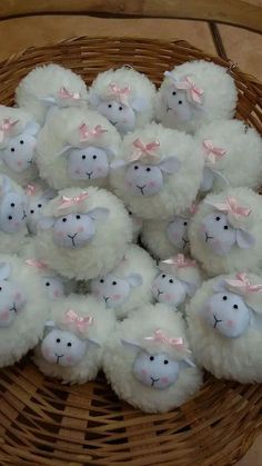 a basket filled with stuffed sheep sitting on top of a table