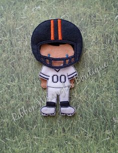 a football player brooch sitting in the grass