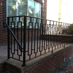 an iron railing on the side of a brick building