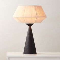 a table lamp sitting on top of a white counter