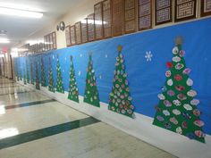 a hallway decorated with christmas trees and snowflakes on the wall in an elementary school