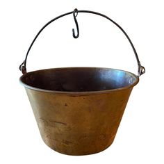 an old metal bucket with a hook hanging from it's side on a white background