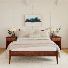 a bedroom with white walls and wooden furniture