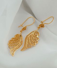 Gold Angel Wing Silver Dangle Earrings 925 Sterling Silver Gold Plated Filigree Floral Earrings Women Handmade Wing Drop Earrings Jewelry Edwardian earrings, anniversary gift her, best friend gift, sparkly earrings Material: 925 Sterling Silver 18K Gold Plated (NICKEL FREE) Length, Drop and Width: 5.5cm X 3.5cm X 1.6cm // 2.15 Inches X 0.6 Inches UPS - FREE, FAST AND TRACKABLE SHIPPING FOR ALL EU COUNTRIES AND USA. Embrace celestial elegance with our Gold Angel Wing Silver Dangle Earrings, a divine fusion of ethereal charm and artisan craftsmanship. Crafted from high-quality 925 Sterling Silver and delicately plated in gold, these enchanting filigree floral earrings are a testament to meticulous handmade artistry. The angel wing design adds a touch of celestial grace, symbolizing protectio Designer Earrings Gold, Elegant Yellow Gold Filigree Plug Earrings, Elegant Hallmarked Plug Earrings For Gift, Gold Filigree Sterling Silver Earrings, Delicate Earrings With Intricate Design For Gift, Elegant Filigree Dangle Plug Earrings, Elegant Dangle Filigree Plug Earrings, Yellow Gold Filigree Earrings For Gift, Elegant Filigree Earrings For A Gift