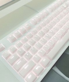 a keyboard and mouse sitting on a desk with the light shining through it's screen