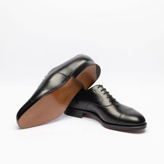 Black calf oxford shoe with stitched cap toe, double leather sole. Fitting F, last 202. Made in England Black Cap Toe Monk Strap Shoes, Luxury Goodyear Welted Oxfords With Round Toe, Luxury Goodyear Welted Round Toe Oxfords, Black Cap Toe Oxfords With Leather Sole, Timeless Oxfords With Leather Lining And Round Toe, Luxury Goodyear Welted Almond Toe Oxfords, Black Cap Toe Loafers With Goodyear Welt, Business Oxfords With Goodyear Welt And Almond Toe, Black Cap Toe Loafers For Derby