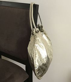 Attractive metallic gathered double-handle hobo bag.

Next-day processing. Shipped in 4-7 days. Gold Bucket Bag With Top Carry Handle, Gold Bucket Shoulder Bag With Top Carry Handle, Gold Shoulder Bucket Bag With Top Carry Handle, Metallic Double Handle Everyday Bag, Metallic Shoulder Bag For Shopping, Gold Hobo Bag With Detachable Handle For Shopping, Gold Hobo Bag With Detachable Handle For Daily Use, Metallic Double Handle Bag For Shopping, Metallic Bags With Adjustable Strap For Daily Use