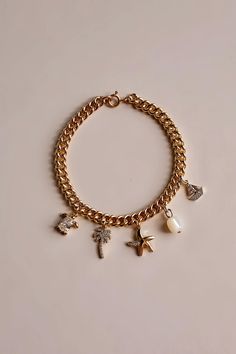 Nautical Gold Filled Charm Bracelet 🐚✨ Custom made to your wrist size so *PLEASE INCLUDE YOUR WRIST SIZE IN THE PERSONALZATION BOX* If you would like to build your own charm bracelet please see my separate listing : Build Your Own Custom Charm Bracelet ✨ 18k Gold Filled Charms included on the bracelet:  * Genuine Shell Pearl * Gold Filled Starfish w/ Swarovski Crystals * Gold Filled Sailboat w/ Swarovski Crystals * Gold Filled Palm Tree w/ Swarovski Crystals * Gold Filled Turtle w/ Swarovski Cr Custom Charm Bracelet, Custom Charms, Jewelry Earrings Hoops, Crystals And Gemstones, Palm Tree, Starfish, Swarovski Crystal, Swarovski Crystals, Gold Filled