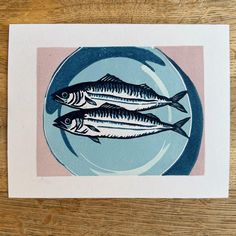 two fish are sitting on a blue plate