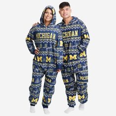 Get some matching family pajamas and dress to impress this holiday season! You won't want to miss these onesie team pajamas! These men's and women's PJ's are comfortable and show off your team spirit in the form of some sweet one piece jammies. Introducing the Michigan Wolverines Ugly Pattern One Piece Pajamas! Don't forget to take your holiday photo with the whole family wearing matching Christmas pajamas! Features Pajama set includes onesie with zipper closure, so you can look good from head t Casual Winter Onesie For Sleep, Casual Winter Sleep Onesie, Casual Long Sleeve Christmas Onesie, Casual Onesie For Sleepovers, Matching Winter Sleepwear For Loungewear, Winter Matching Sleepwear For Loungewear, Casual Christmas Loungewear Onesie, Casual Cotton Onesie For Game Day, Michigan Go Blue