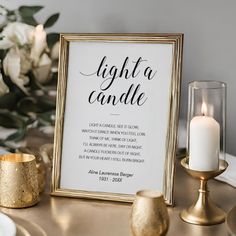 a table with candles and a sign that says light a candle