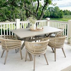 an outdoor table and chairs on a deck