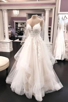 a white wedding dress on display in a store