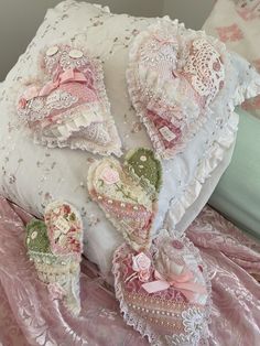 the pillows and shoes are on the pink bed sheet with ruffles around them