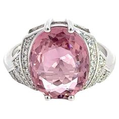 Ring (Matching Earrings Available) 18K White Gold  Weight 4,75 GMS Tourmaline -1/4.86 Cts   Diamond-38/0.129 Cts Size-52 Step back in time with this exquisite Art Deco-inspired ring, elegantly fashioned from 4.75 grams of 18k white gold. This refined piece features a central 4.86-carat pink tourmaline, radiating with vibrant hues that capture the spirit of the roaring twenties. Surrounding this stunning gem are 38 round diamonds, totaling 0.129 carats, that add a sparkling brilliance to the piece. Sized at 52, this ring combines vintage charm with a touch of modern luxury, making it a perfect addition to any sophisticated jewelry collection. With a heritage of ancient fine Swiss jewelry traditions, NATKINA is a Geneva based jewellery brand, which creates modern jewellery masterpieces suita The Roaring Twenties, Sophisticated Jewelry, Ring Matching, Pink Sparkle, Roaring Twenties, Makeup Designs, Step Back, Dream Jewelry, Back In Time