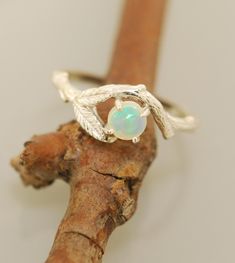 Twin Leaf Opal Ring Original Design Made in the USA A beautiful 5 mm opal sits under a curved branch in this ring. Two leaves rest along side in this ring for the nature loving types. The ring is all sterling silver. The opal is ethiopan and grade AAA. If you want a different stone or metal choice please email me. Engagement Ring Opal, Engagement Ring Alternative, Etsy Engagement Rings, Antler Ring, Twig Ring, Leaf Engagement Ring, Alternative Engagement Ring, Rose Gold Flower, Branch Ring