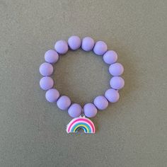 Purple bracelet for girl silicon bead bracelet little girl bracelet rainbow charm bracelet purple beaded bracelet kids bracelet rainbow gift This delightfully cute kids rainbow bracelet is perfect for your little one! Constructed with an elastic cord, it is both easy and safe for your child to put on and take off. The purple silicon beads, paired with the rainbow charm, make this bracelet the perfect accessory for your kid. Item Details *Material: Silicon beads, Elastic cord *Bracelet size: 6in Adjustable Purple Charm Bracelet For Birthday, Cute Purple Charm Bracelet For Friendship, Cute Rainbow Charm Bracelet For Gift, Cute Rainbow Charm Bracelet As Gift, Cute Purple Beaded Bracelets For Birthday, Cute Purple Jewelry For Friendship, Playful Hypoallergenic Purple Jewelry, Playful Purple Hypoallergenic Jewelry, Cute Rainbow Bracelets For Birthday