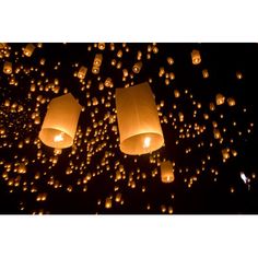 many lanterns floating in the air at night