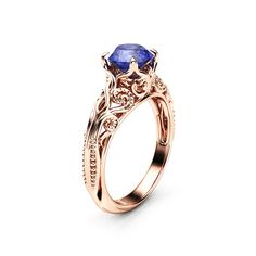 a gold ring with an oval blue sapphire stone in the center and intricate filigrees around the band