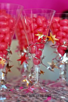 some pink and gold stars are in wine glasses