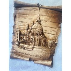 a wooden plaque with an image of a building on it