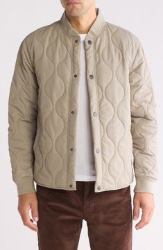 Layer on this lightweight onion-quilted jacket constructed with an easy snap closure and stretchy ribbed trim. Front snap closure Blade collar Front welt pockets Lined, with 100% polyester fill 100% polyester with 97% polyester, 3% spandex ribbed trim Machine wash, line dry Imported Quilted Button-up Winter Outerwear, Quilted Long Sleeve Utility Outerwear, Quilted Cotton Utility Jacket With Long Sleeves, Long Sleeve Cotton Puffer Jacket With Ribbed Cuffs, Cotton Puffer Jacket With Ribbed Cuffs, Winter Cotton Quilted Jacket With Snap Buttons, Cotton Quilted Winter Jacket With Snap Buttons, Casual Quilted Outerwear With Relaxed Fit, Casual Khaki Quilted Jacket For Spring