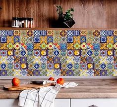 a kitchen counter topped with lots of fruit next to a wall mounted tile backsplash