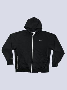 ✤ Vintage Item ✈ Ships worldwide from Bratislava, Slovakia ✂ Materials: cotton, embroidery  Size: XL Condition: 10/10  Elevate your sporty wardrobe with this sleek Nike Standard Zip-up hoodie in size XL. Engineered with Dri-FIT technology, it promises to deliver classic style coupled with modern performance. The black hue and minimalist design make it a versatile piece for both active and casual outings. Made in Vietnam, it ensures comfort and durability. Don't miss out on this athletic staple! Functional Cotton Hoodie For Streetwear, Functional Hooded Streetwear Tops, Functional Hooded Tops For Streetwear, Sportswear Tops With Logo For Streetwear, Cotton Track Jacket With Logo Detail, Black Functional Cotton Track Jacket, Winter Streetwear Tops With Logo Detail, Cotton Long Sleeve Track Jacket With Logo, Black Cotton Outerwear With Logo Detail