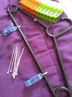 the medical instruments are laying out on the purple sheet with their handles and wires attached to them