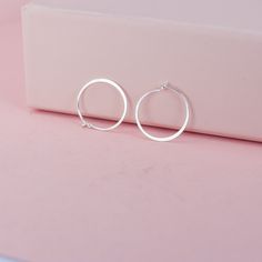 "These tiny silver hoops are shaped out of sterling silver or 14K white gold and hammered until they shimmer and shine.  I wanted to make a simple hoop that would be perfect for wearing daily and would be so comfortable that you could forget that you're even wearing them. The posts are tuck into a loop catch on the backside of the earring. This particular pair of earrings from the line is a tiny circle - about 3/4\".  Made from responsible and recycled metals - sterling silver and 14K white gold. Please note that the white gold is unplated and does contain nickel. More silver hoops: https://www.etsy.com/shop/LotusStone?ref=seller-platform-mcnav&search_query=silver+hoops Shop other small hoops: https://www.etsy.com/shop/LotusStone?ref=seller-platform-mcnav&search_query=small+hoops More 14k Minimalist White Gold Hoop Earrings With Sterling Silver Clasp, Sterling Silver Huggie Earrings For Gifting, Gift Sterling Silver Huggie Earrings, Hammered Open Circle Hoop Earrings For Gift, Hammered Open Circle Hoop Earrings As A Gift, Minimalist Hoop Earrings With Sterling Silver Clasp As Gift, Minimalist Hoop Earrings With Sterling Silver Clasp, Gift Hammered Open Circle Hoop Earrings, Silver Hypoallergenic Open Circle Hoop Earrings