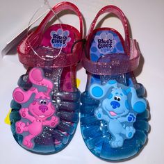 two blue and pink shoes with cartoon characters on them